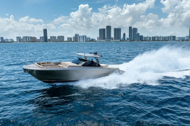 The Image of 2019 CNM Continental 54 yacht cruising on ocean with city skyline backdrop. - 0