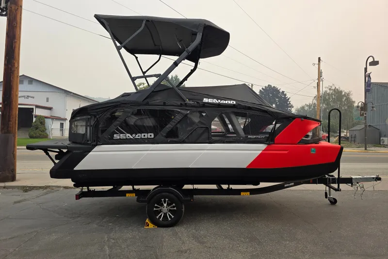 Slide: The Image of 2024 Seadoo Switch Sport boat on trailer, featuring sleek design and canopy. - 2