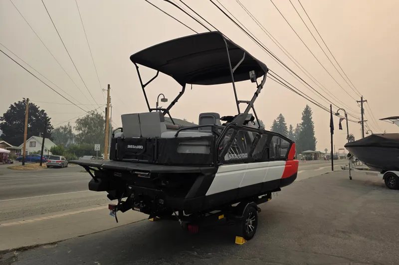Slide: The Image of 2024 Seadoo Switch Sport boat parked on a street, showcasing modern design and features. - 1