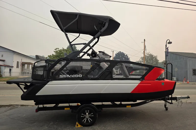 The Image of 2024 Seadoo Switch Sport boat on trailer, featuring sleek design and vibrant colors. - 0