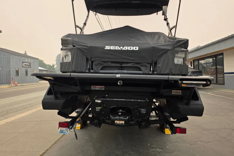 Slide: The Image of 2024 Seadoo Switch Sport rear view, covered, parked on a street. - 4