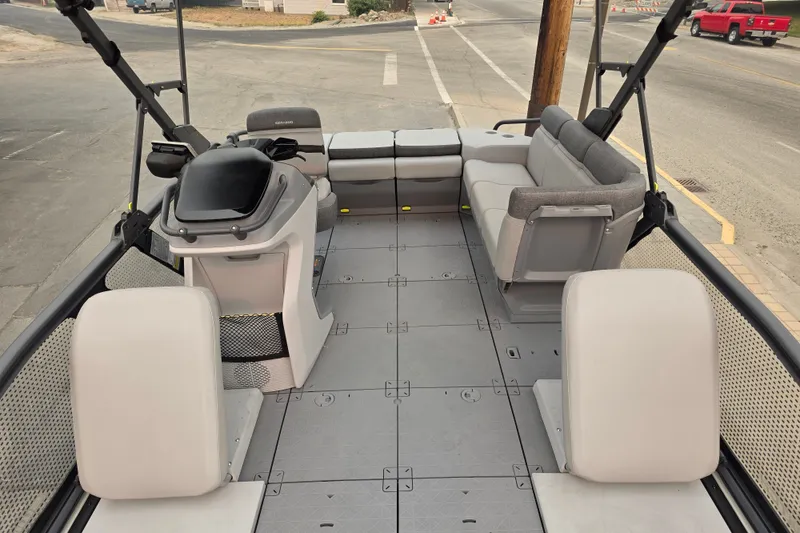 Slide: The Image of 2024 Seadoo Switch Sport interior with seating and helm, parked on a street. - 12