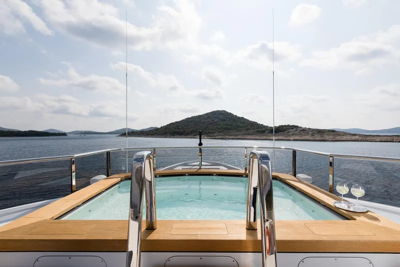 Slide: The Image of Luxurious Alia Yachts 60M (2016) with pool, ocean view, and elegant deck setting. - 21