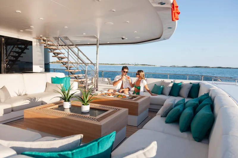 Slide: The Image of Luxurious Alia Yachts 60M deck with elegant seating, ocean view, and couple dining, 2016 model. - 5