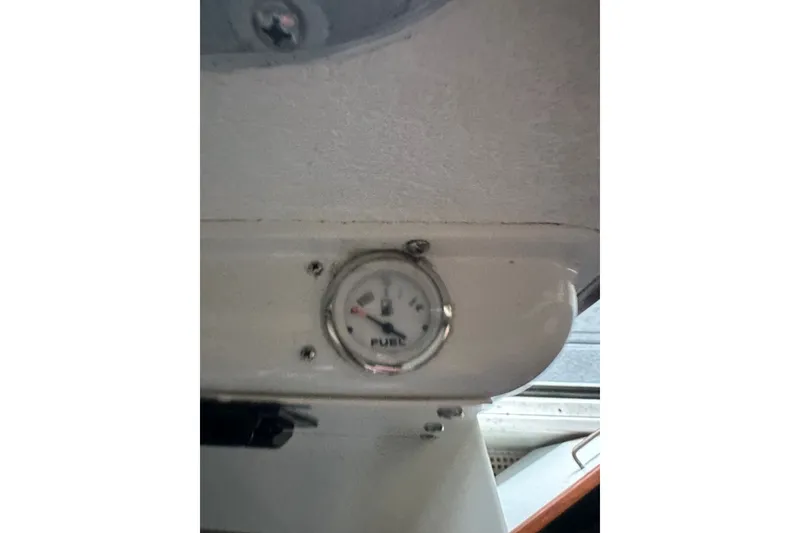 Slide: The Image of Fuel gauge on a 1999 Skagit Orca 24 boat dashboard. - 29