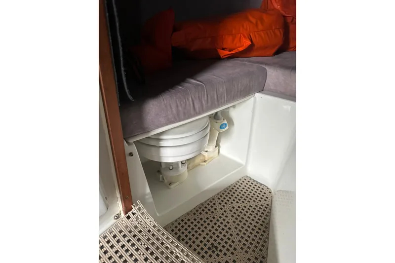 Slide: The Image of Interior of a 1999 Skagit Orca 24 boat showing a compact marine toilet. - 32