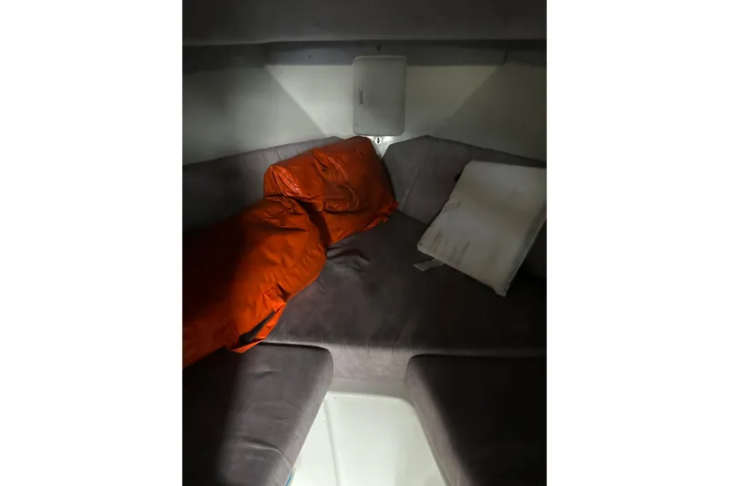 Slide: The Image of Cozy cabin interior of a 1999 Skagit Orca 24 boat with orange sleeping bag. - 30