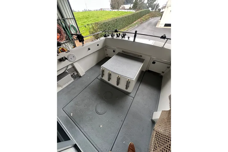 Slide: The Image of 1999 Skagit Orca 24 boat deck with storage and fishing rod holders. - 9