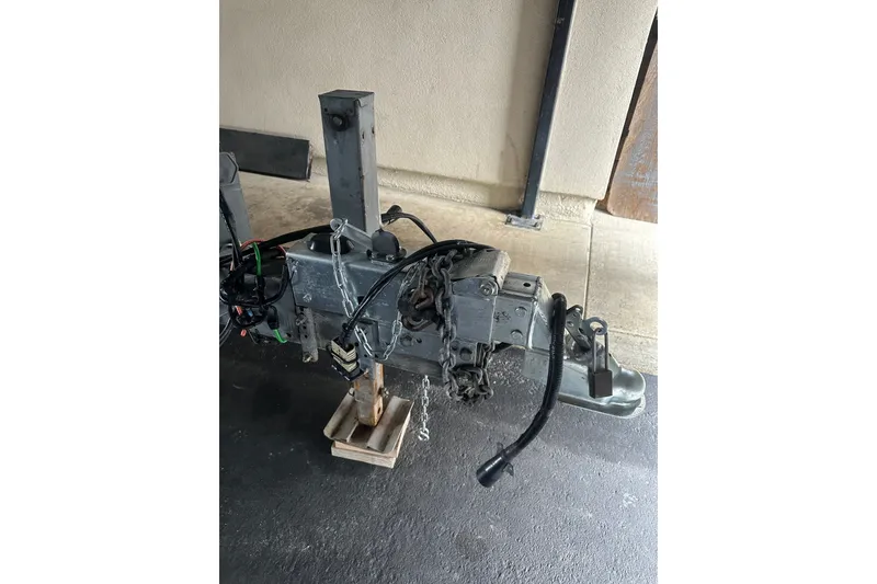 Slide: The Image of Trailer hitch of a 1999 Skagit Orca 24 boat, secured with chains and a lock. - 37