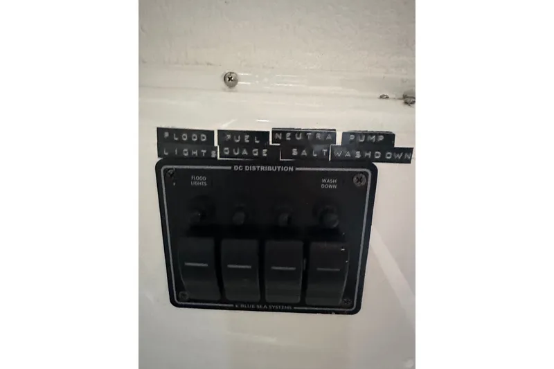 Slide: The Image of Control panel with labeled switches on a 1999 Skagit Orca 24 boat. - 27
