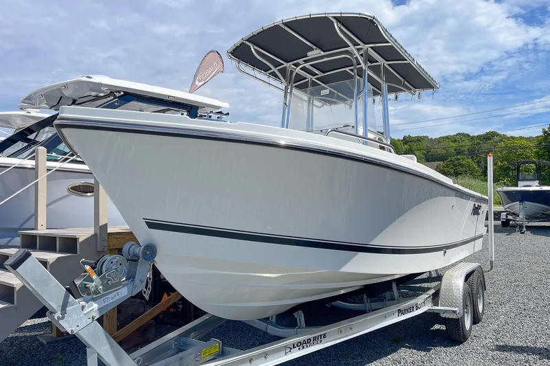 The Image of 2027 Parker 210 Coastal Elite boat on trailer, displayed outdoors under a blue sky. - 0