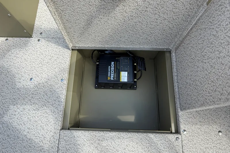 Slide: The Image of Storage compartment with Minn Kota Precision charger in 2026 Lund 1875 Alaskan SS boat. - 17