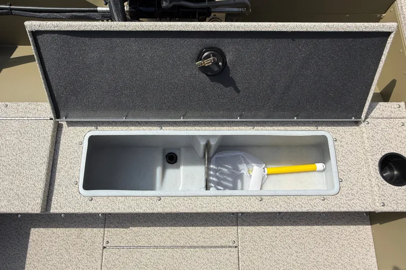 Slide: The Image of Open storage compartment on 2026 Lund 1875 Alaskan SS boat with a yellow-handled net. - 25
