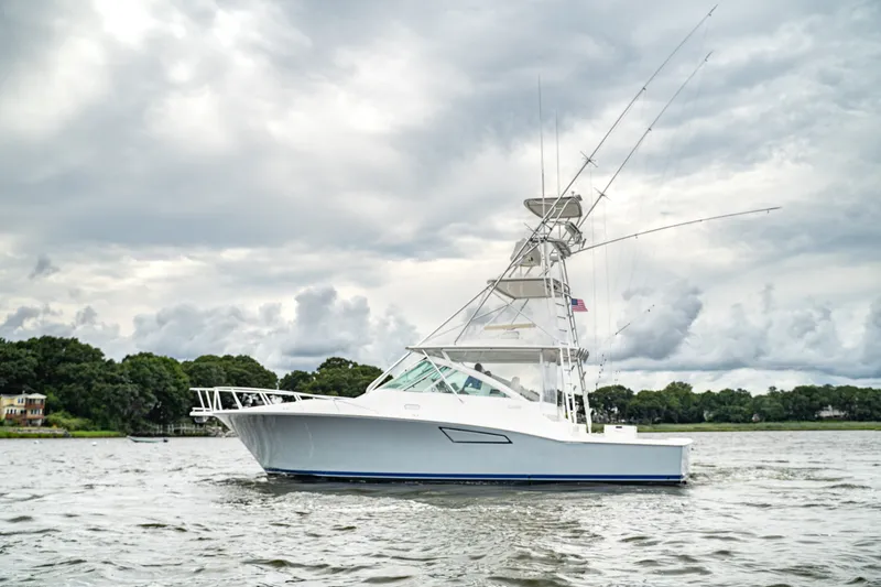 The Image of 2005 Cabo 40 Express yacht on a cloudy day, cruising on calm waters. - 1