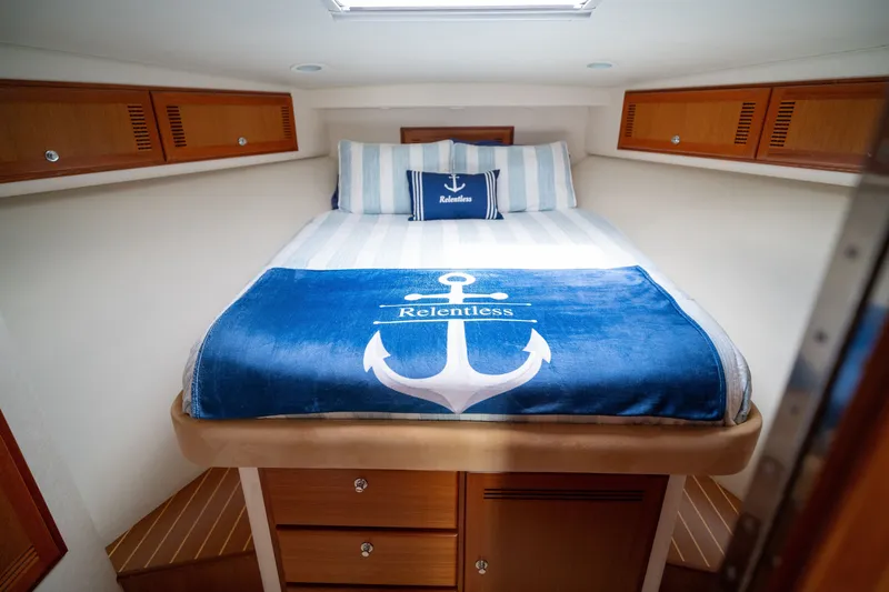 Slide: The Image of Cozy cabin interior of 2005 Cabo 40 Express with nautical-themed bedding. - 17