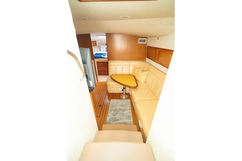 Slide: The Image of Interior of 2005 Cabo 40 Express yacht with beige seating and wooden accents. - 14