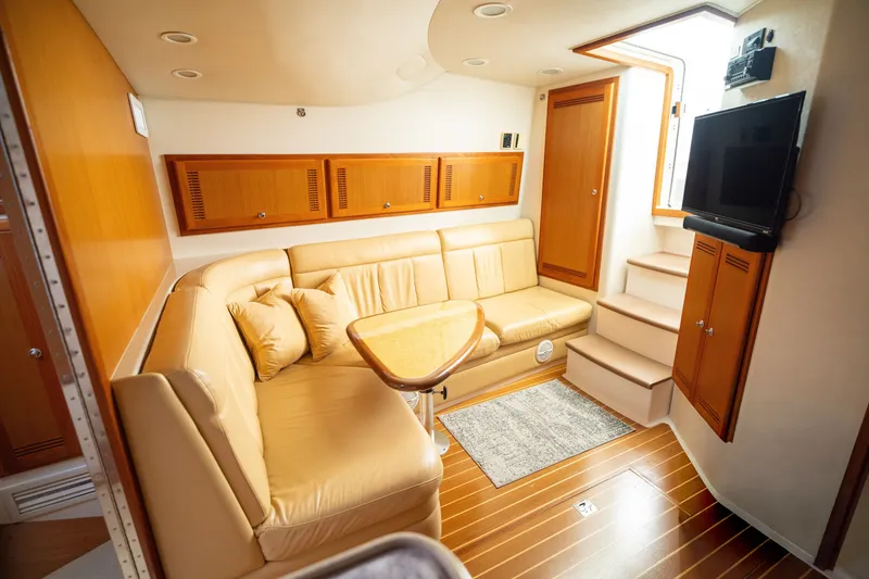 Slide: The Image of Luxurious interior of 2005 Cabo 40 Express yacht with leather seating and wooden accents. - 15