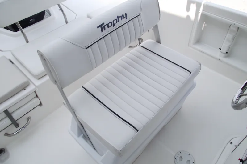 Slide: The Image of 2022 Bayliner Element F21 boat interior with white cushioned seating and "Trophy" branding. - 15