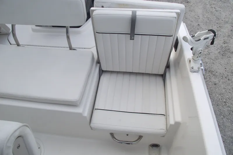 Slide: The Image of White seating area on 2022 Bayliner Element F21 boat, featuring cushioned seats and rod holder. - 23