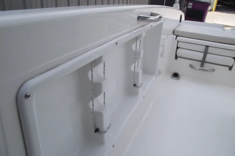 Slide: The Image of 2022 Bayliner Element F21 boat interior with white seating and storage compartments. - 14