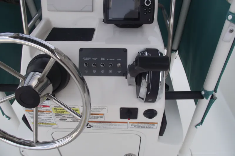 Slide: The Image of 2022 Bayliner Element F21 helm with steering wheel and control panel. - 17