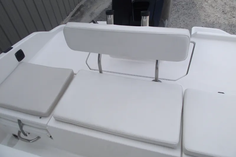 Slide: The Image of 2022 Bayliner Element F21 boat seating area with white cushions and backrest. - 18