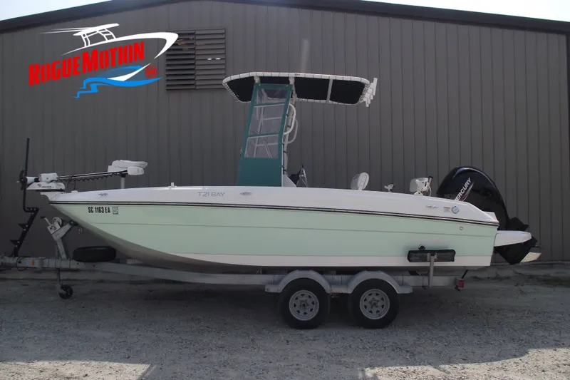 The Image of 2022 Bayliner Element F21 boat on trailer, parked outside a building. - 0
