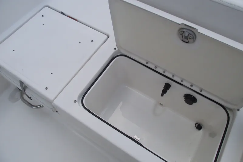 Slide: The Image of Open storage compartment on 2022 Bayliner Element F21 boat. - 26