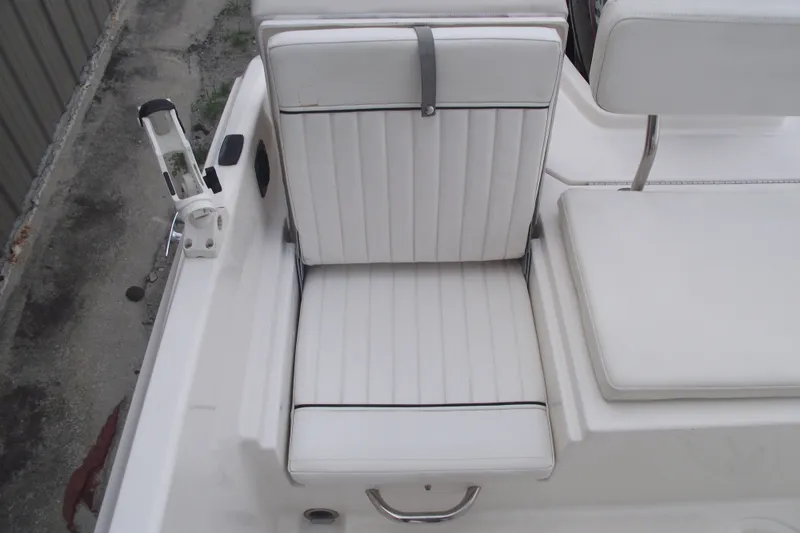 Slide: The Image of White seating on 2022 Bayliner Element F21 boat, featuring sleek design and rod holder. - 20