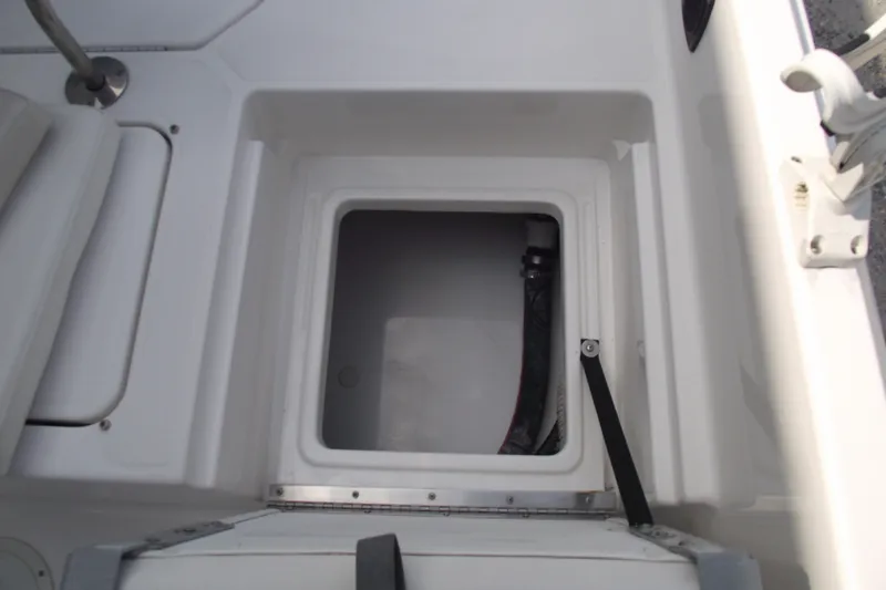 Slide: The Image of 2022 Bayliner Element F21 boat storage compartment with open hatch. - 24