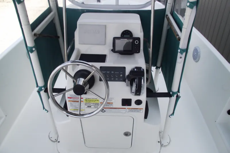 Slide: The Image of 2022 Bayliner Element F21 boat console with steering wheel and navigation equipment. - 16