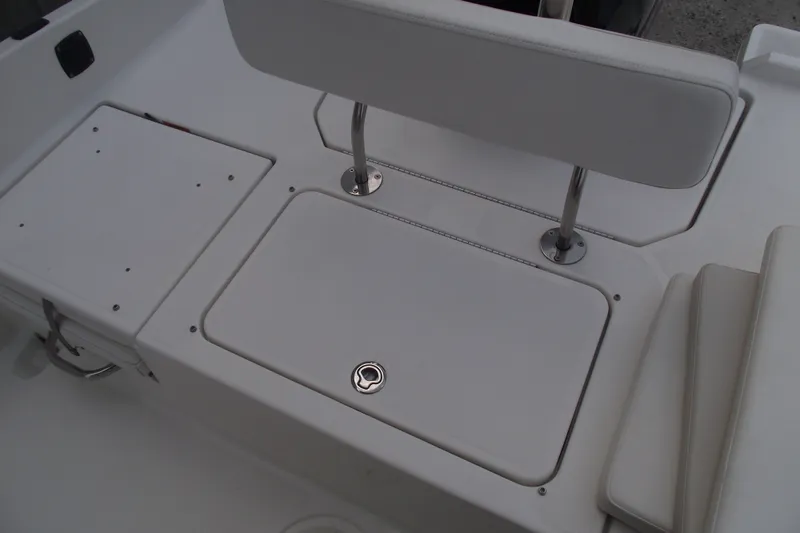 Slide: The Image of 2022 Bayliner Element F21 boat interior with seating and storage compartments. - 25