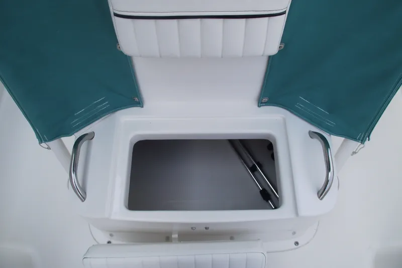 Slide: The Image of 2022 Bayliner Element F21 boat storage compartment with teal covers and stainless steel handles. - 13