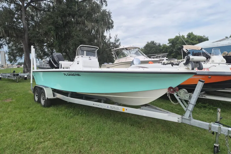 The Image of Kenner Vision 2103 boat from 2006 on trailer, parked on grass. - 1