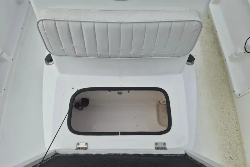 Slide: The Image of Open storage compartment on a 2006 Kenner Vision 2103 boat with cushioned seat. - 22