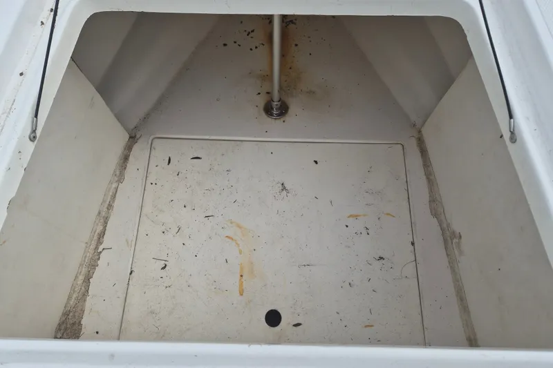 Slide: The Image of Empty storage compartment of a 2006 Kenner Vision 2103 boat, showing some dirt and wear. - 27