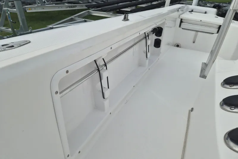 Slide: The Image of 2006 Kenner Vision 2103 boat interior with storage compartment and rod holders. - 20