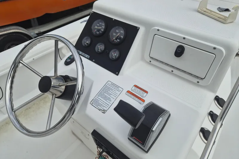 Slide: The Image of Steering console of a 2006 Kenner Vision 2103 boat with gauges and controls. - 14