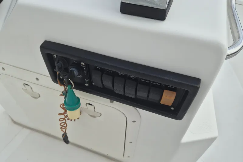 Slide: The Image of Control panel of a 2006 Kenner Vision 2103 boat with key and switches. - 16