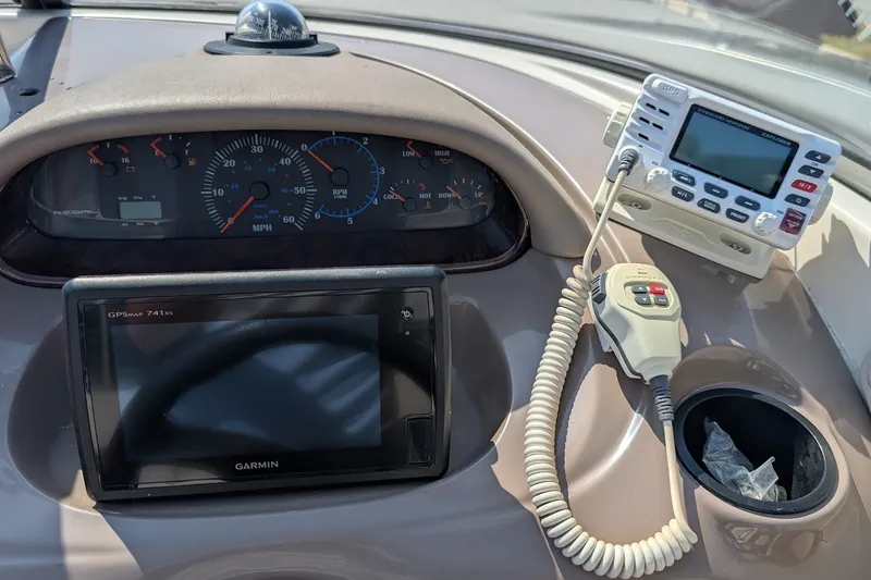 Slide: The Image of Dashboard of a 2002 Regal 2450 LSC boat with GPS and radio equipment. - 32