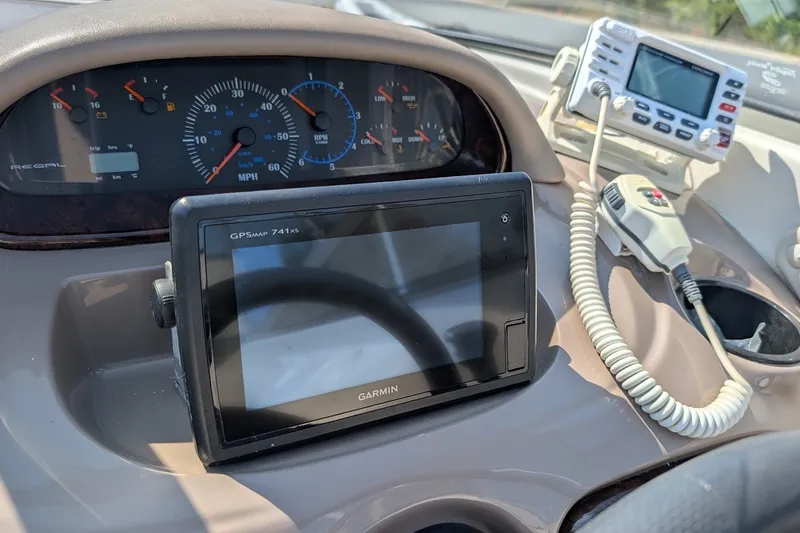Slide: The Image of Dashboard of a 2002 Regal 2450 LSC boat with Garmin GPS and radio equipment. - 37