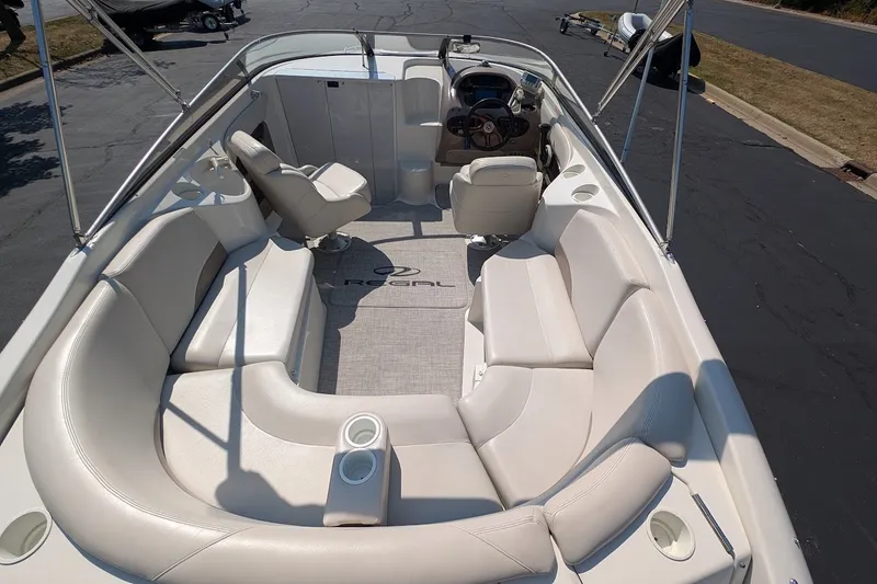 Slide: The Image of 2002 Regal 2450 LSC boat interior with white seating and steering console. - 17