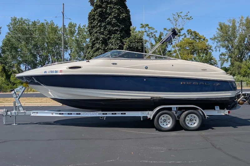 Slide: The Image of 2002 Regal 2450 LSC boat on trailer, parked outdoors. - 1
