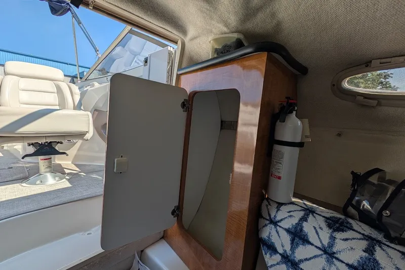 Slide: The Image of Interior of a 2002 Regal 2450 LSC boat with seating and storage. - 39
