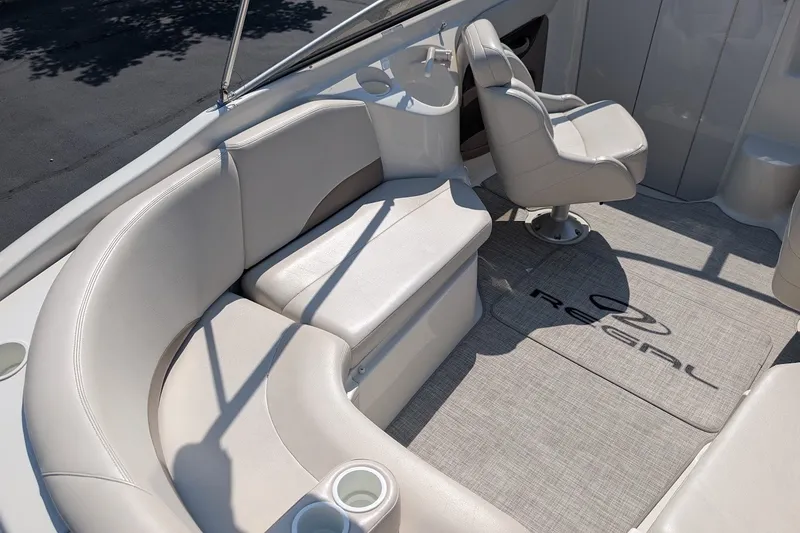 Slide: The Image of 2002 Regal 2450 LSC boat interior with white seating and captain's chair. - 18