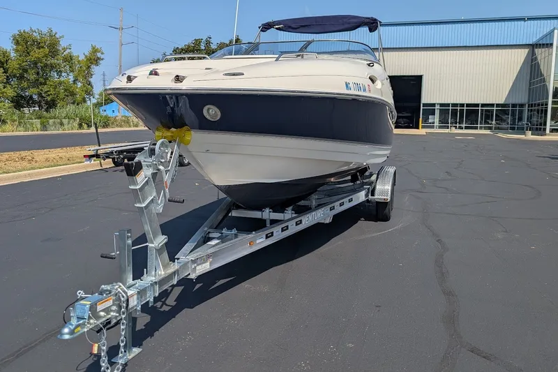 Slide: The Image of 2002 Regal 2450 LSC boat on trailer in parking lot, sunny day. - 9