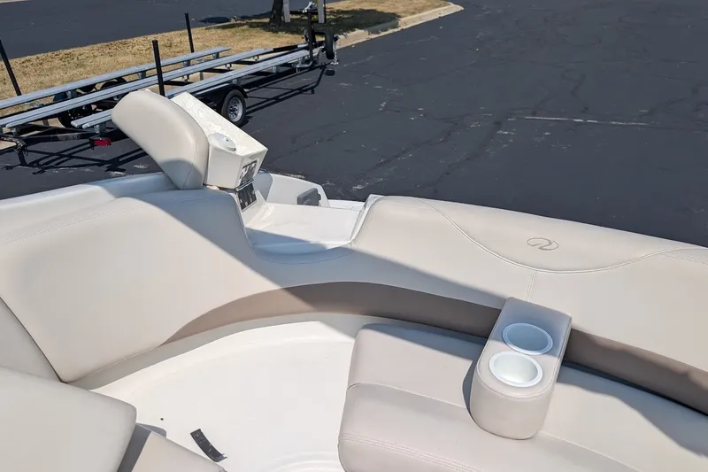 Slide: The Image of 2002 Regal 2450 LSC boat interior with beige seating and cup holders. - 22