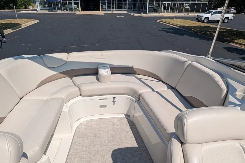 Slide: The Image of 2002 Regal 2450 LSC boat interior with beige seating and cup holder. - 24
