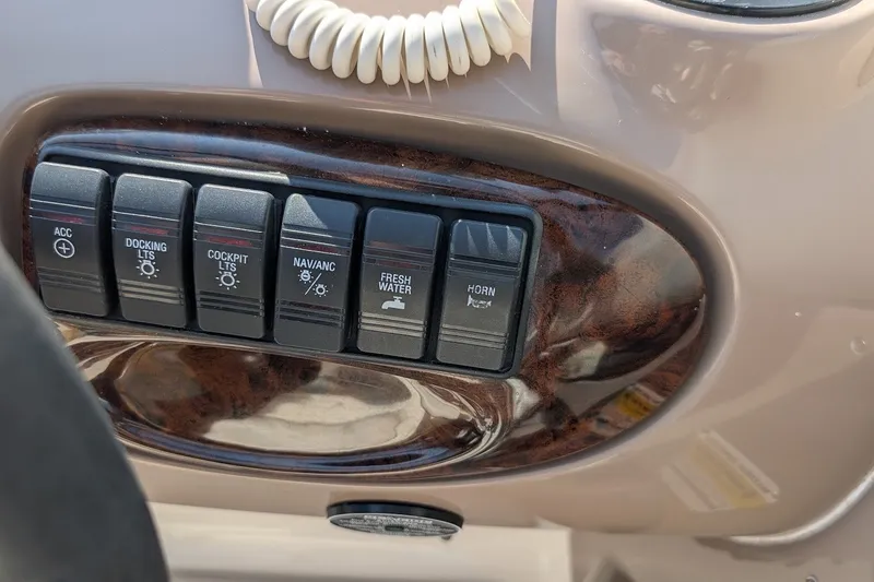 Slide: The Image of Control panel of a 2002 Regal 2450 LSC boat with labeled switches. - 35