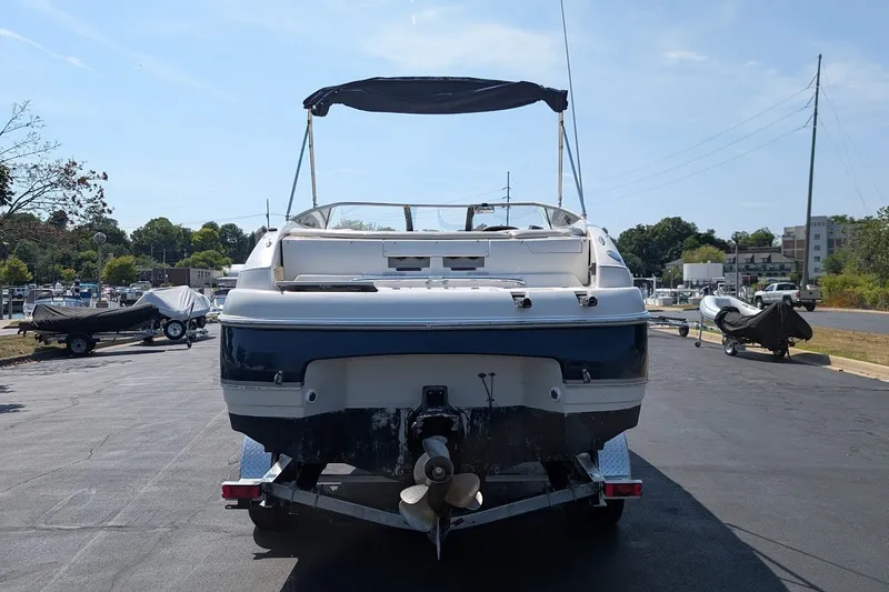Slide: The Image of 2002 Regal 2450 LSC boat on trailer, rear view, sunny day. - 3